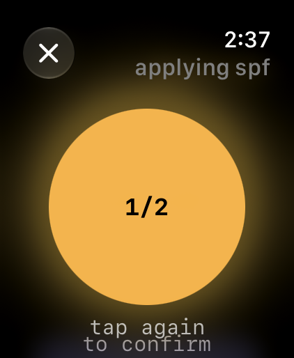 The confirmation screen: an amber sun labelled one of two, with the instruction to tap again to confirm.